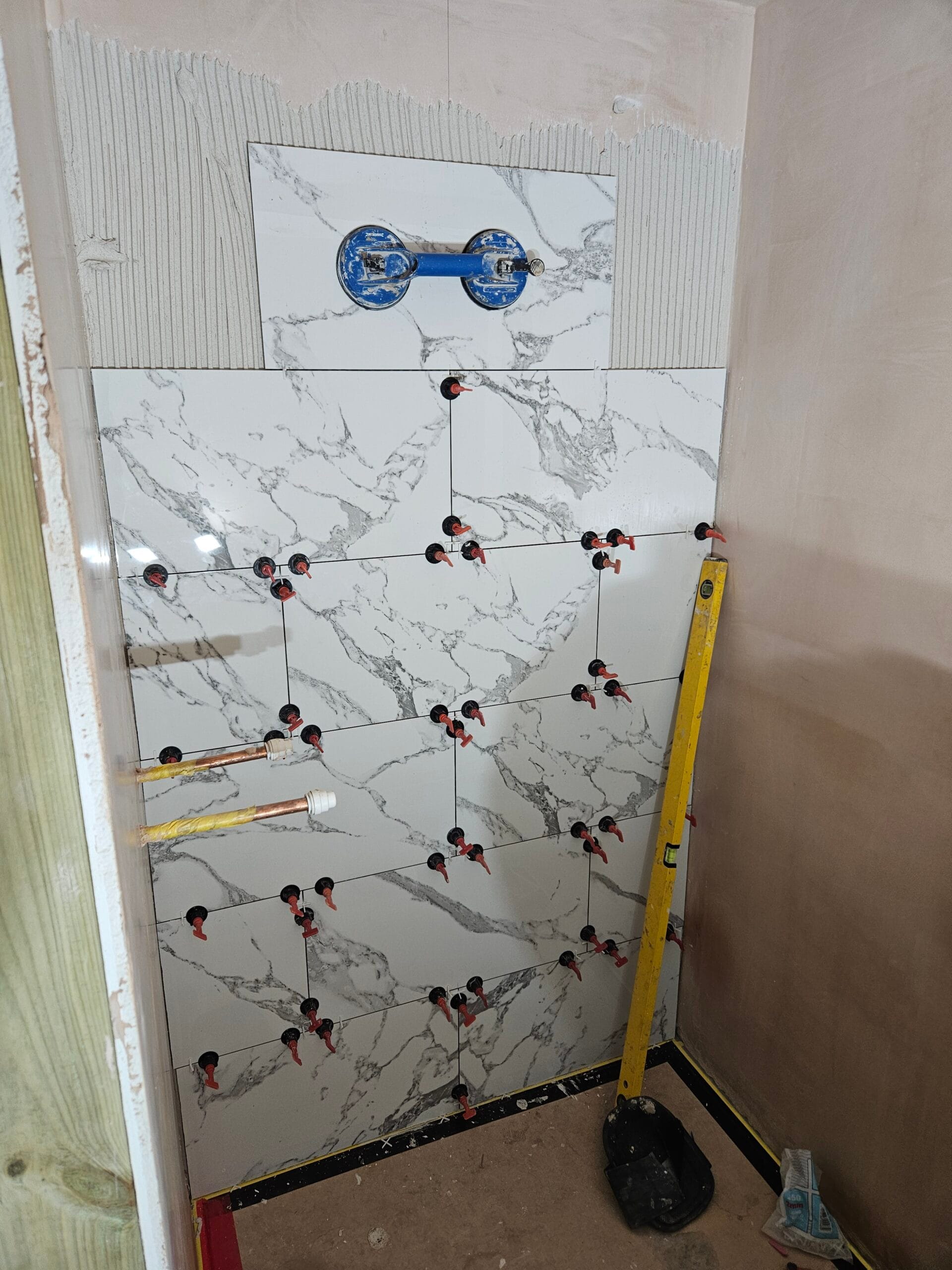 New fres tiles being fitted to a new build flat in london for commercial property customer